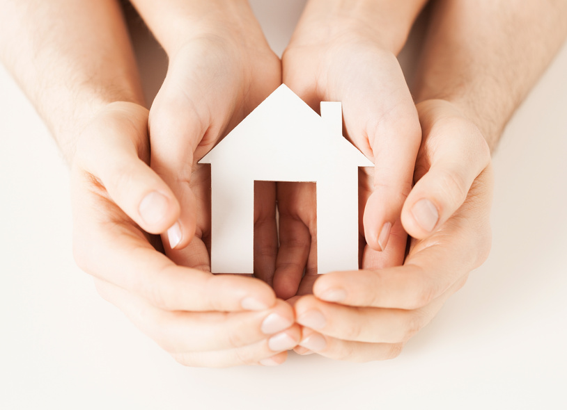 woman and hands with paper house